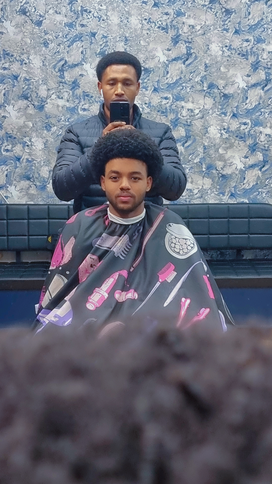 Afro blowout finish, client in the chair
