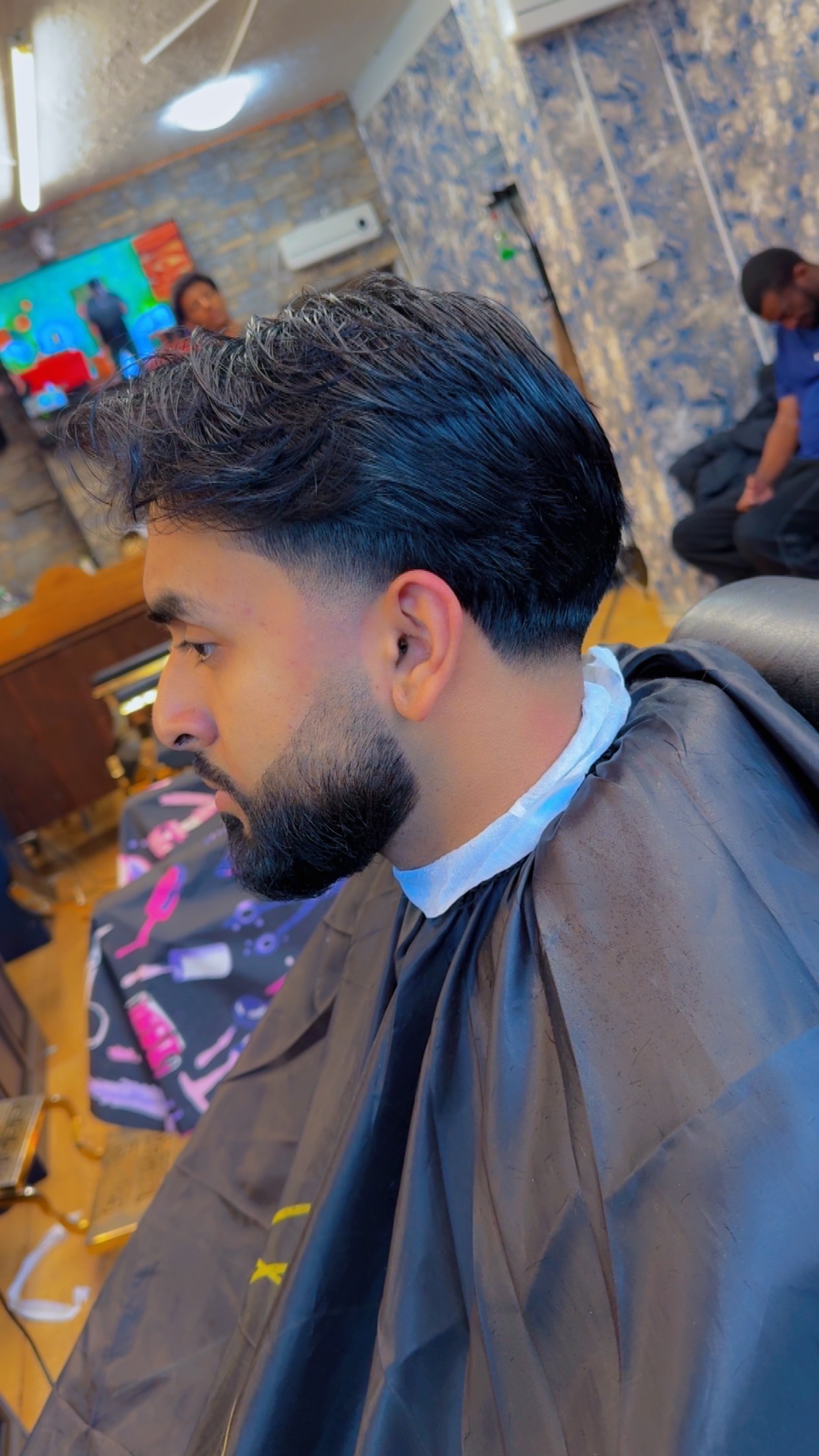 Tapered pompadour with a sharp beard line